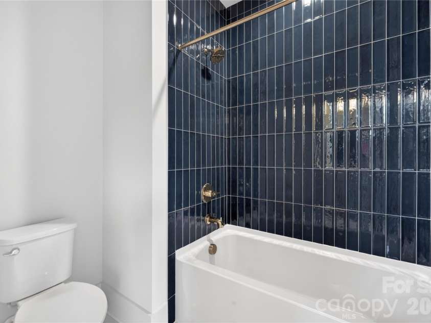 7237 Westrow Avenue, Charlotte, NC 28278.  MLS# CAR4311743, YatesRealty ID 1030. Bath #2 showcases a wonderful soaker tub in a tile oasis.