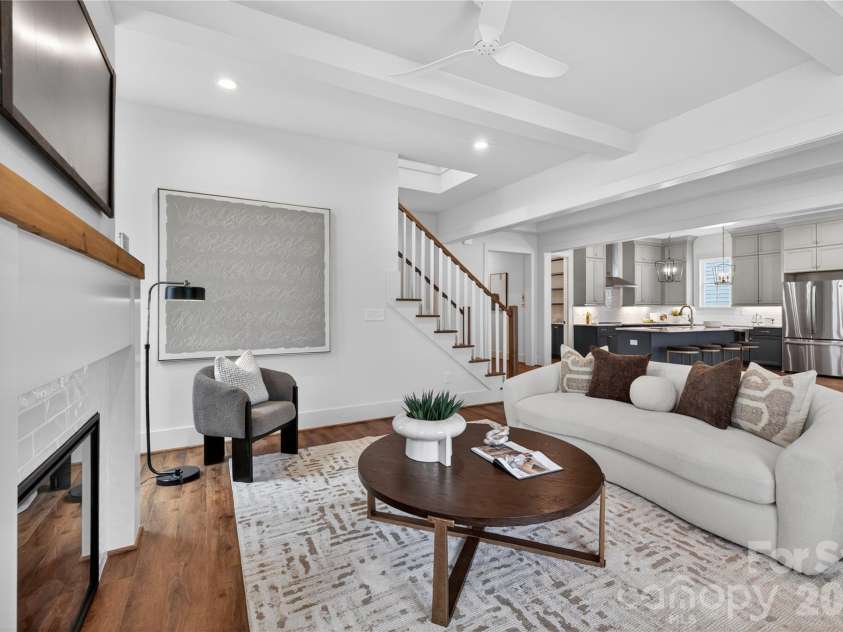 7237 Westrow Avenue, Charlotte, NC 28278.  MLS# CAR4311743, YatesRealty ID 1030. Family room is filled with natural light and showcases ceiling beams. A cozy fireplace enhances this inviting space.