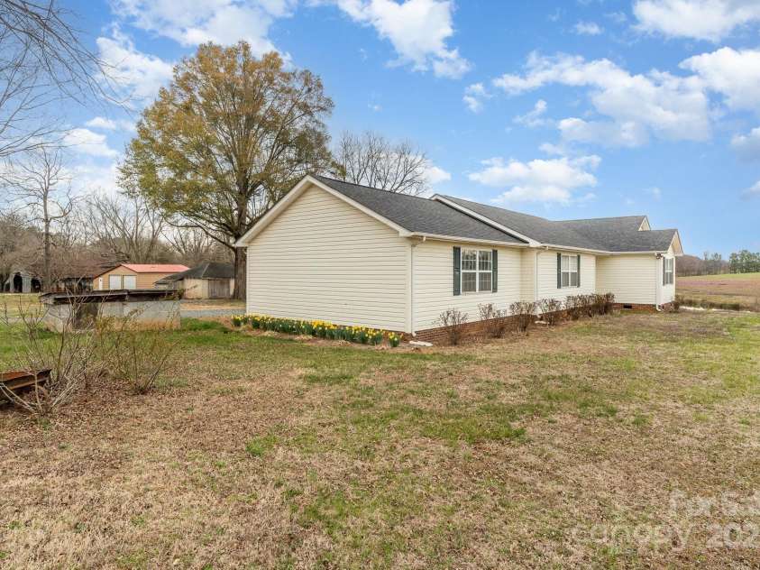 24697 Ramsey Drive, Albemarle, NC 28001.  MLS# CAR4227470, YatesRealty ID 10321. Side view of home