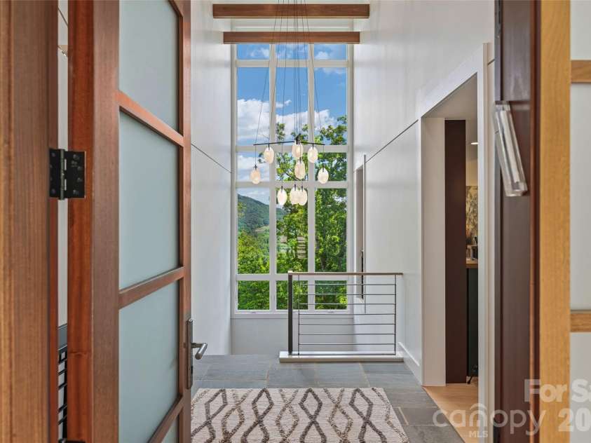 1121 Timberbluff Way, Arden, NC 28704.  MLS# CAR4389216, YatesRealty ID 10325. A welcoming introduction to the home's sophisticated modern design