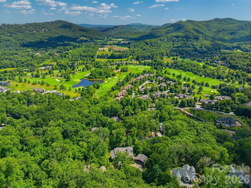 1121 Timberbluff Way, Arden, NC 28704.  MLS# CAR4389216, YatesRealty ID 10325. Aerial perspective revealing the home's remarkable mountain setting