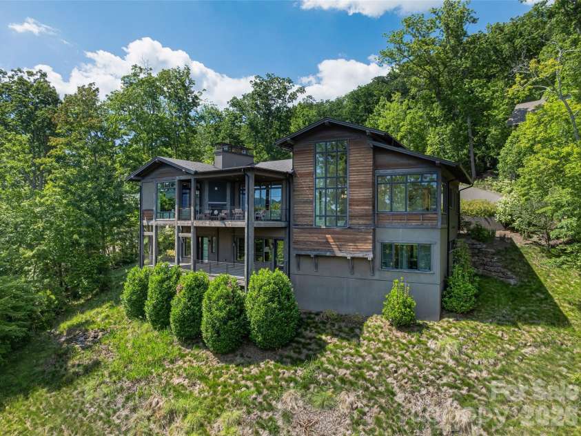 1121 Timberbluff Way, Arden, NC 28704.  MLS# CAR4389216, YatesRealty ID 10325. Architecturally distinctive mountain residence nestled into a private natural setting