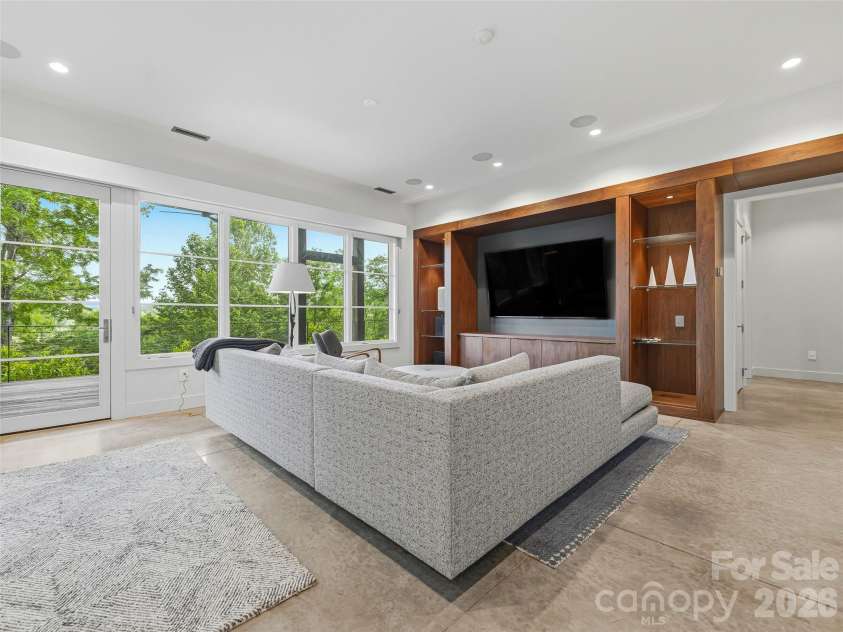 1121 Timberbluff Way, Arden, NC 28704.  MLS# CAR4389216, YatesRealty ID 10325. Family room opening directly to covered outdoor living