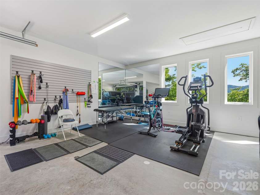 1121 Timberbluff Way, Arden, NC 28704.  MLS# CAR4389216, YatesRealty ID 10325. Flexible garage space currently configured as a fitness area