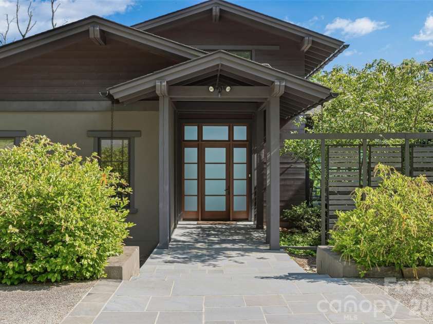 1121 Timberbluff Way, Arden, NC 28704.  MLS# CAR4389216, YatesRealty ID 10325. Inviting covered entry framed by native landscaping