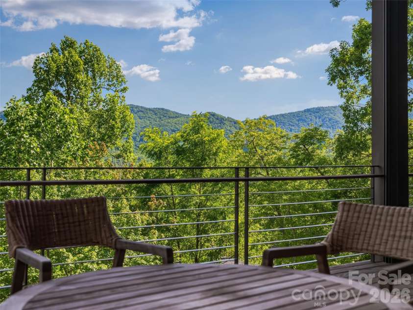 1121 Timberbluff Way, Arden, NC 28704.  MLS# CAR4389216, YatesRealty ID 10325. Main-level outdoor living with sweeping mountain backdrop