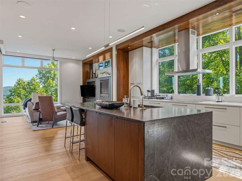 1121 Timberbluff Way, Arden, NC 28704.  MLS# CAR4389216, YatesRealty ID 10325. Open-concept living with kitchen, den, and mountain views seamlessly connected