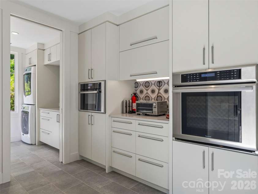 1121 Timberbluff Way, Arden, NC 28704.  MLS# CAR4389216, YatesRealty ID 10325. Well-appointed prep kitchen with adjacent laundry facilities