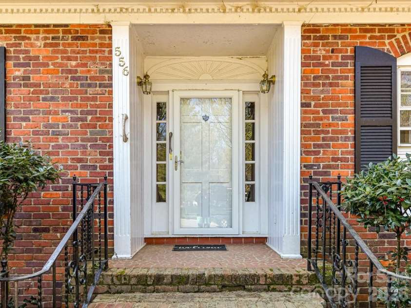 556 Eastway Street, Davidson, NC 28036.  MLS# CAR4365491, YatesRealty ID 10328. Welcoming front entry with classic brick detailing and covered stoop, ready for your personal touch and updates.