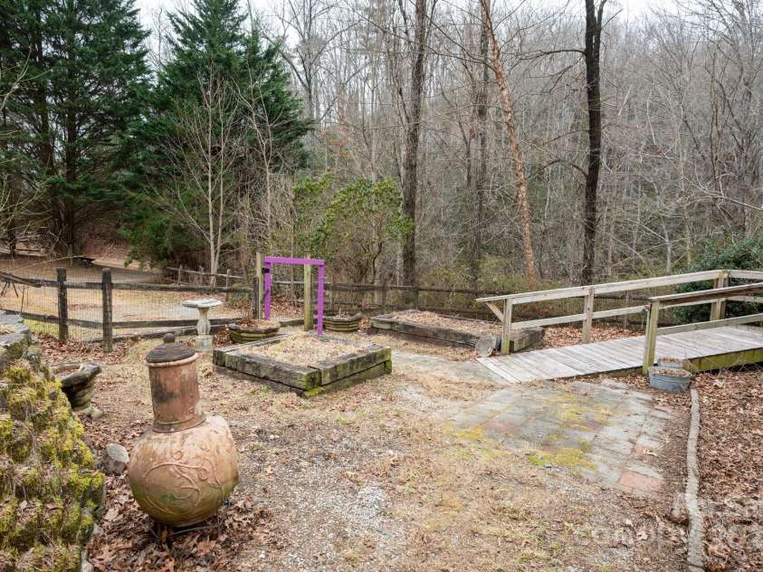 242 Breezy Mountain Lane, Mills River, NC 28759.  MLS# CAR4215866, YatesRealty ID 10330. Cute raised beds and walkway to front porch.  Yard completely fenced in at one time.  Hasn't been pet tested in a couple years. :)