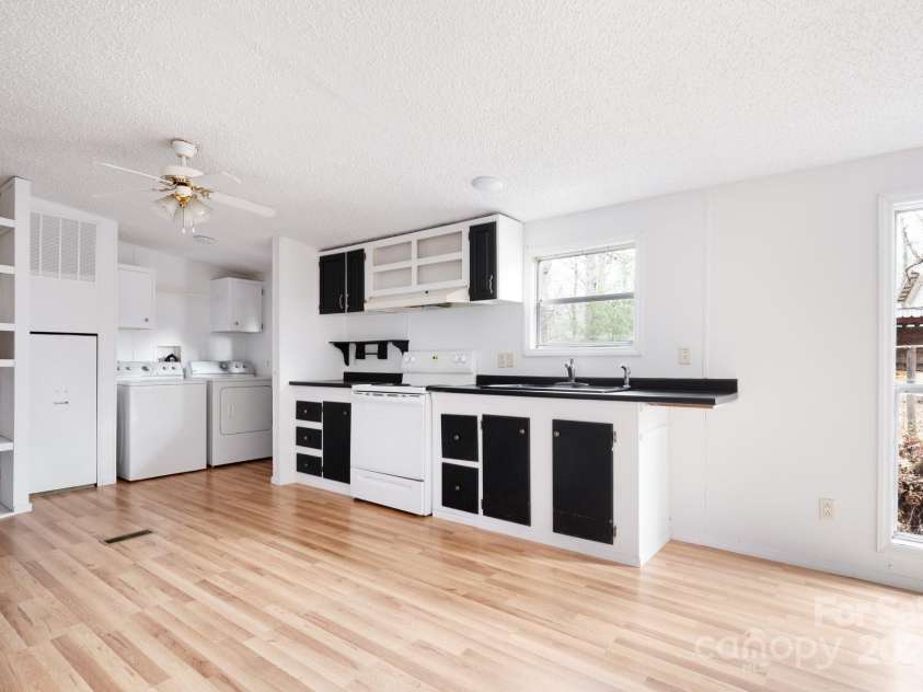 242 Breezy Mountain Lane, Mills River, NC 28759.  MLS# CAR4215866, YatesRealty ID 10330. Large kitchen area with washer and dryer.