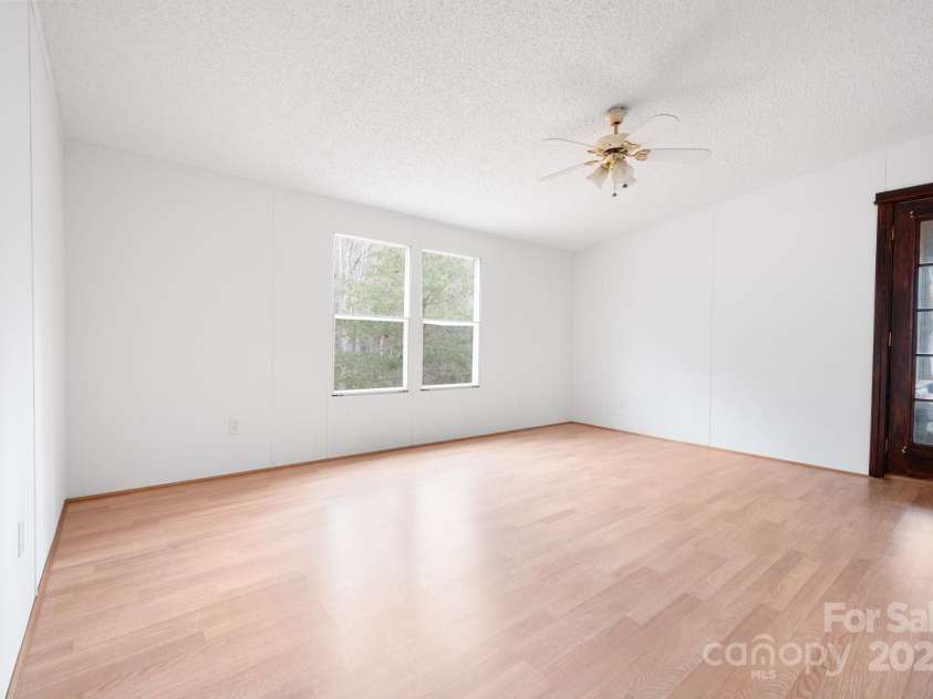 242 Breezy Mountain Lane, Mills River, NC 28759.  MLS# CAR4215866, YatesRealty ID 10330. Primary bedroom with side porch entry.