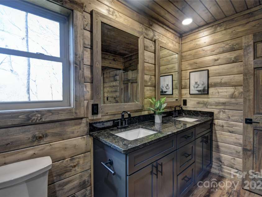 601 Tater Patch Road, Maggie Valley, NC 28751.  MLS# CAR4251873, YatesRealty ID 10378. Primary en-suite bath with dual vanity sinks