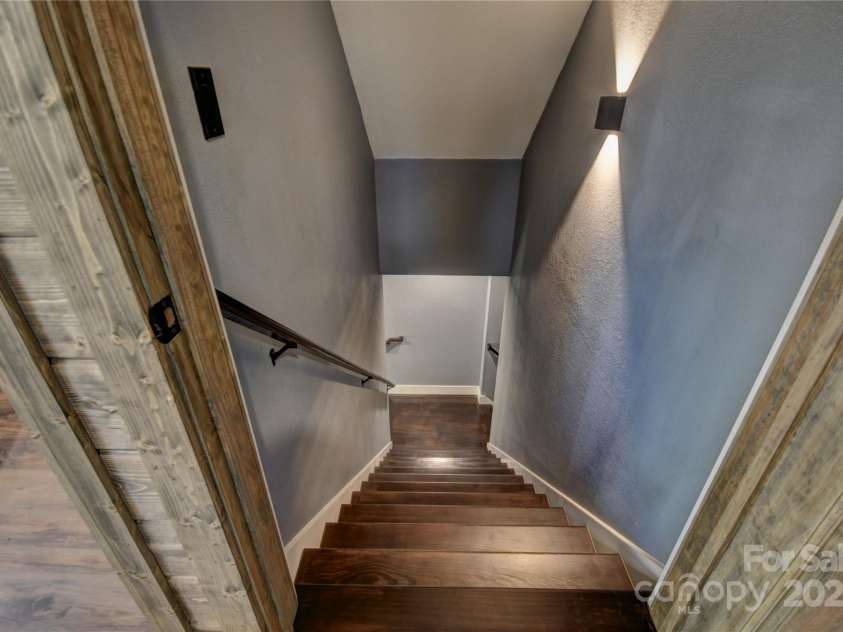 601 Tater Patch Road, Maggie Valley, NC 28751.  MLS# CAR4251873, YatesRealty ID 10378. Stairs from the main level to the lower level