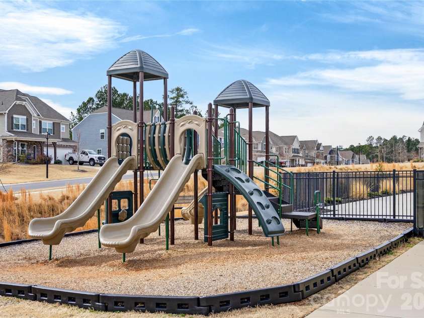 113 Saidin Lane, Troutman, NC 28166.  MLS# CAR4363898, YatesRealty ID 10408. Playground area outside the fenced pool. 