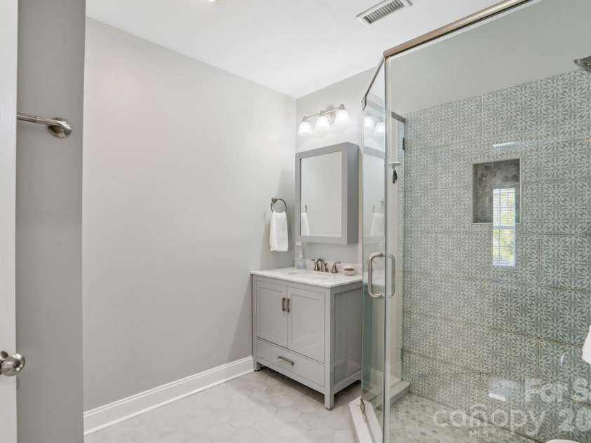 10056 Paisley Drive, Charlotte, NC 28269.  MLS# CAR4364202, YatesRealty ID 10429. Full bath includes an updated vanity, and tiled walk-in shower.
