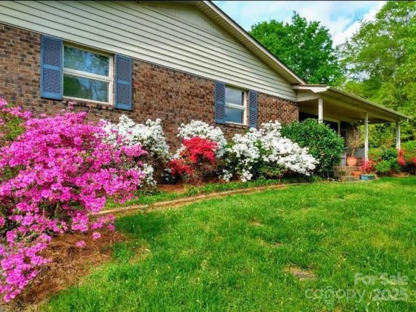 5303 Rogers Road, Monroe, NC 28110.  MLS# CAR4312504, YatesRealty ID 1046. Spring 2025 photo with azaleas in bloom.