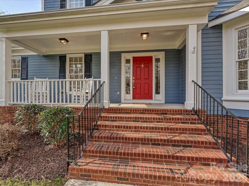 306 Ashby Drive, Davidson, NC 28036.  MLS# CAR4358205, YatesRealty ID 10461. Welcoming wide brick steps leading to  covered front porch