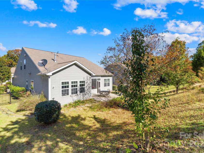 137 Chertsey Drive, Mooresville, NC 28115.  MLS# CAR4316531, YatesRealty ID 10472. Backyard with fruit trees