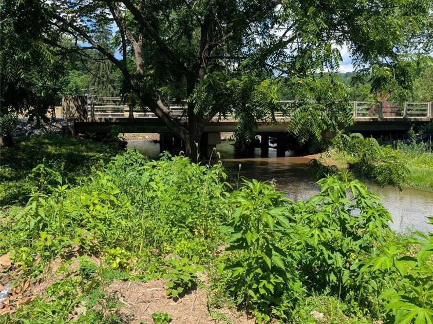 203 Catawba Avenue, Old Fort, NC 28762.  MLS# CAR4252894, YatesRealty ID 10474. View of bridge from yard