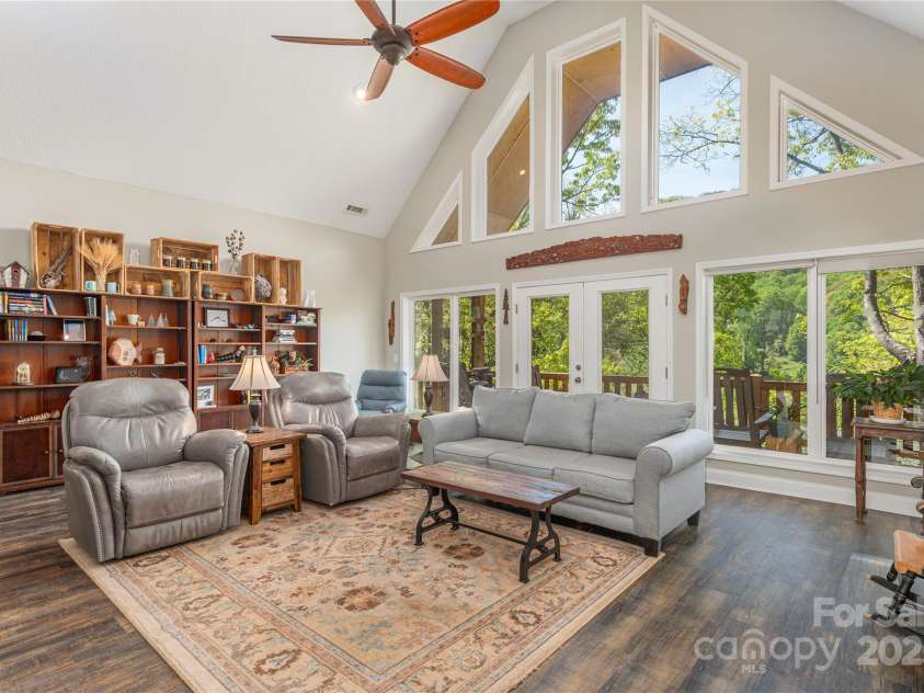 186 Timucua Trail, Waynesville, NC 28786.  MLS# CAR4254132, YatesRealty ID 10475. Living room opens to deck.
