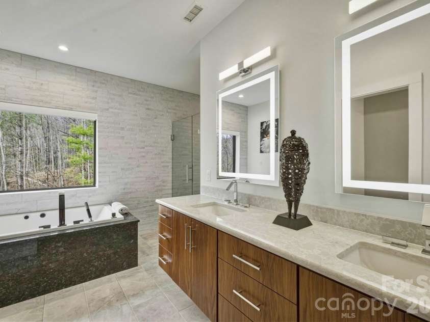 1416 High Valley Way, Lenoir, NC 28645.  MLS# CAR4353473, YatesRealty ID 10476. The bathroom in the primary bedroom suite is a tranquil spa-like 