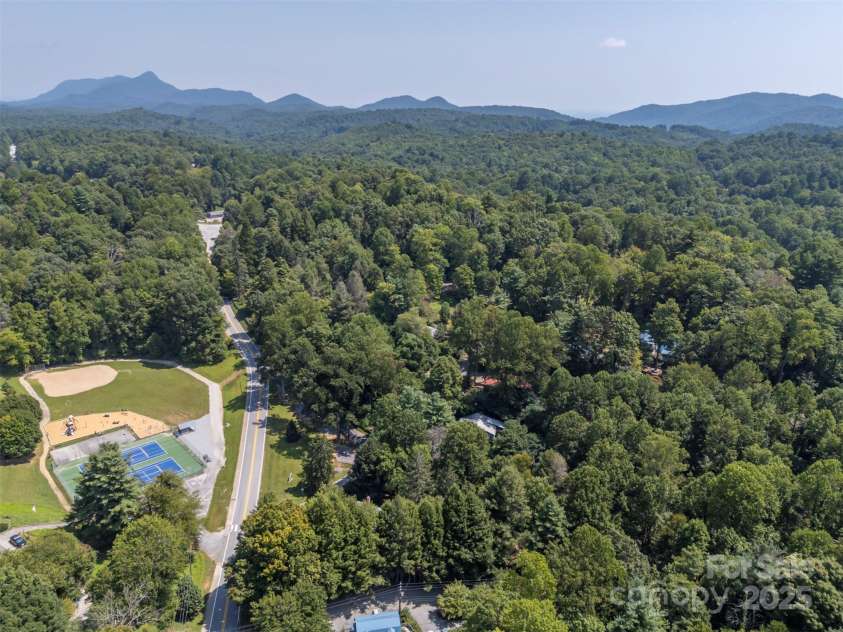 172 formerly 153 Main Street, Saluda, NC 28773.  MLS# CAR4225037, YatesRealty ID 1048. View east showing School playground and pickle ball/tennis courts. Laughter of children playing during school recess is a lovely sound that fills the air.