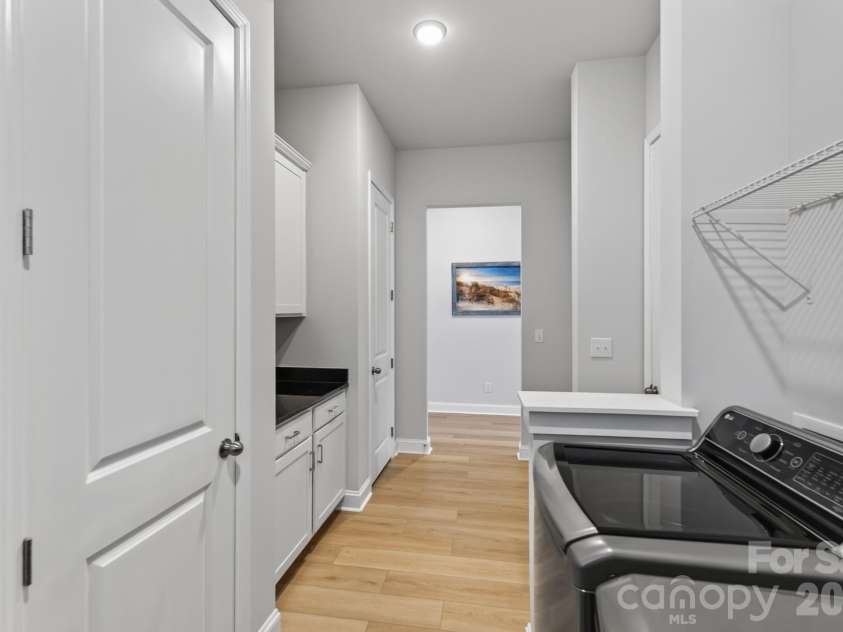 1306 Idyllic Lane, Waxhaw, NC 28173.  MLS# CAR4400609, YatesRealty ID 10501. Spacious Laundry Room with linen and storage closets