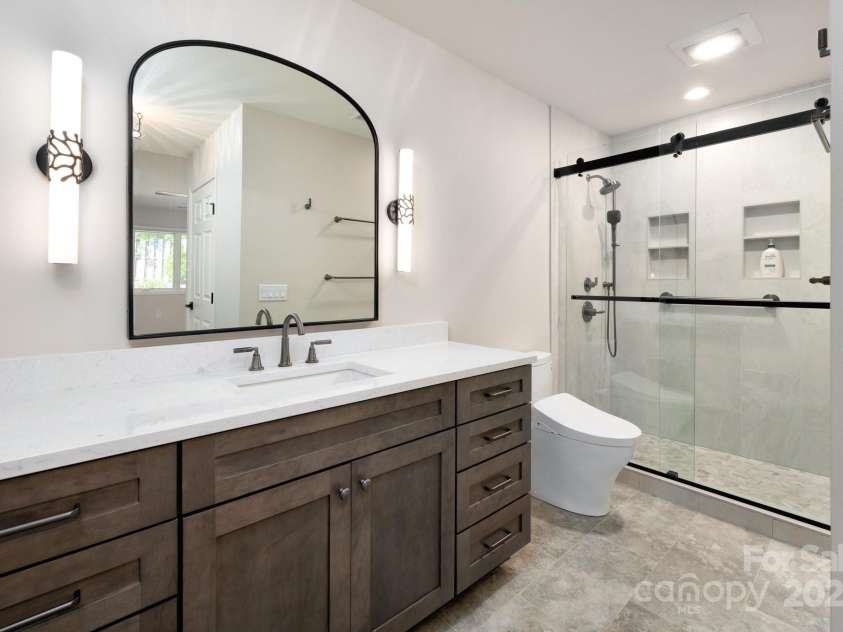 19 Beekeeper Trail, Swannanoa, NC 28778.  MLS# CAR4251601, YatesRealty ID 10506. Ensuite Full Bath with Quartz-Topped Vanity and Tiled, Walk-In Shower