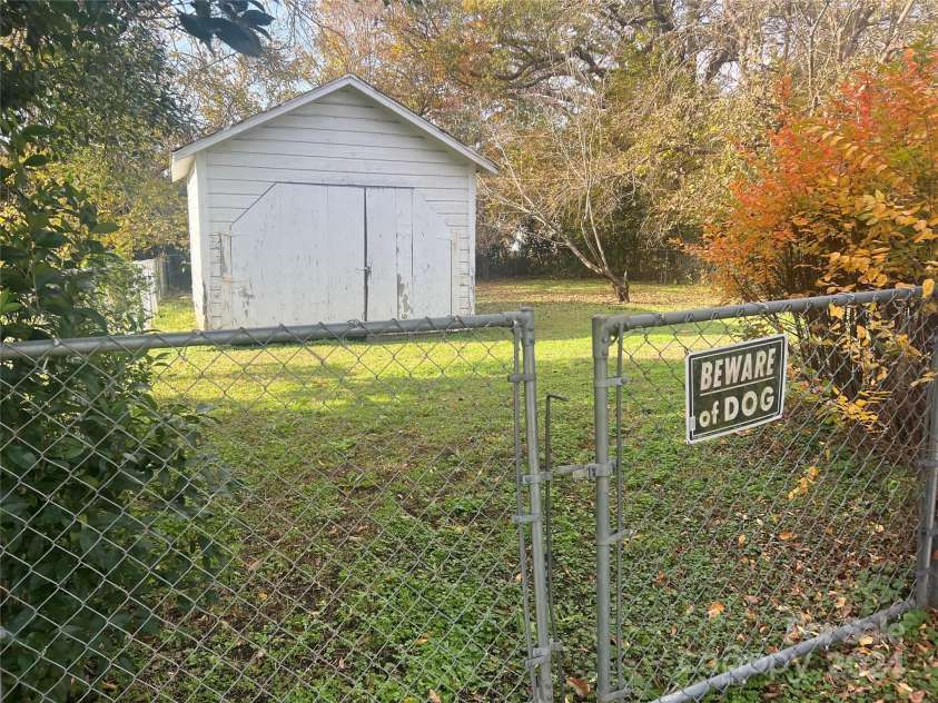 707 7th Street, Spencer, NC 28159.  MLS# CAR4204240, YatesRealty ID 1052. Fenced rear yard with storage building