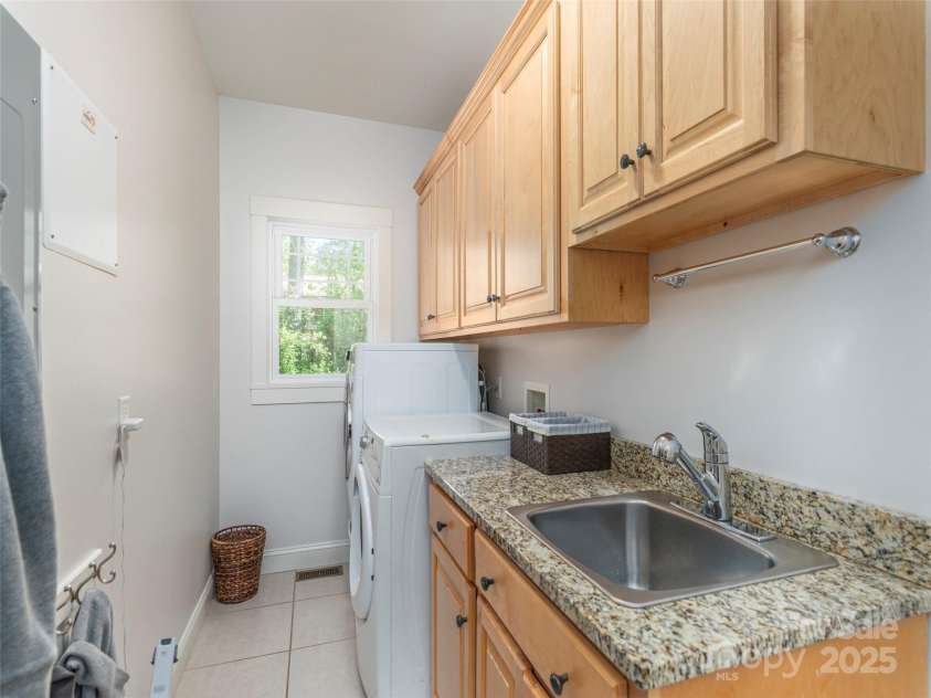 35 Mann Drive, Asheville, NC 28805.  MLS# CAR4252485, YatesRealty ID 10548. Good sized laundry room on the Main, with abundant storage and workspace