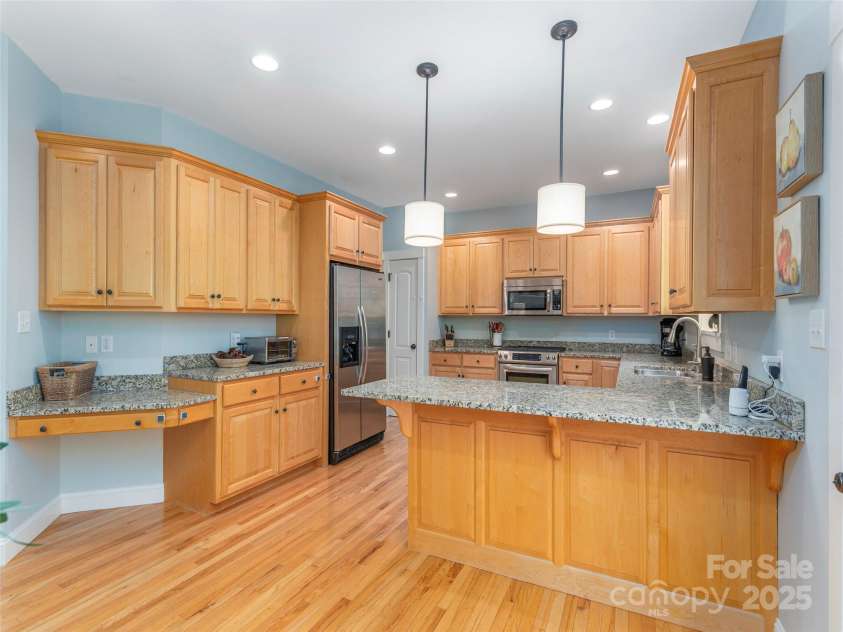 35 Mann Drive, Asheville, NC 28805.  MLS# CAR4252485, YatesRealty ID 10548. Kitchen with abundant storage, workspace, and breakfast bar