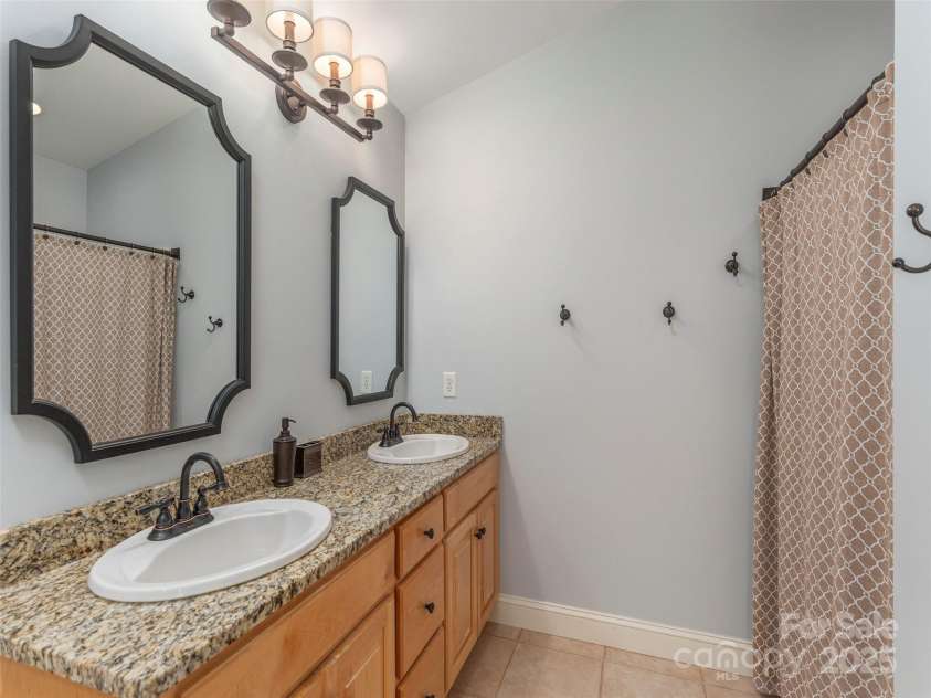 35 Mann Drive, Asheville, NC 28805.  MLS# CAR4252485, YatesRealty ID 10548. Primary bathroom with double vanities