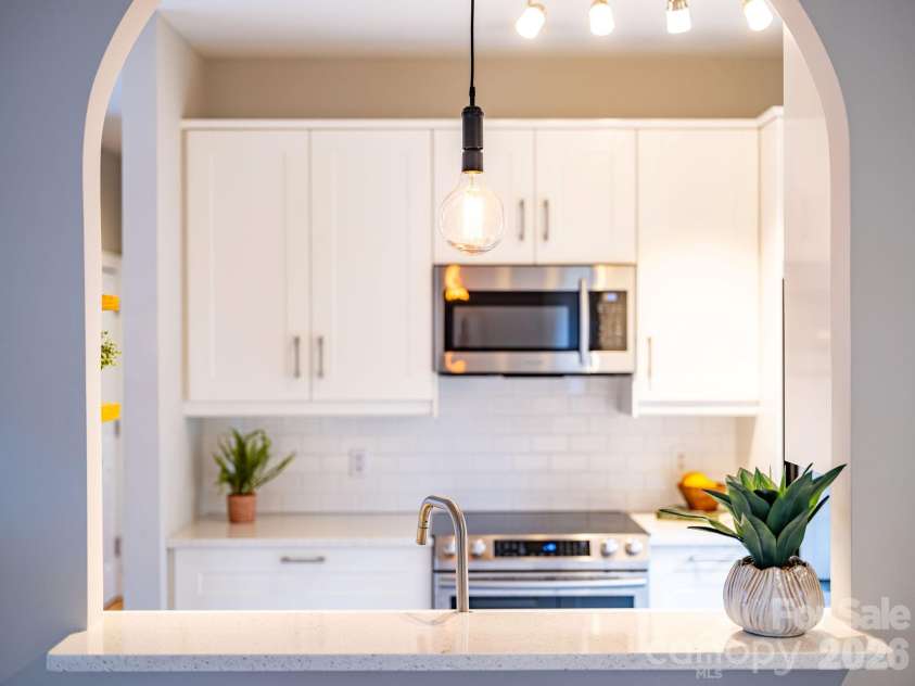 8 Lamar Avenue, Asheville, NC 28803.  MLS# CAR4365889, YatesRealty ID 10551. Arched kitchen passthrough