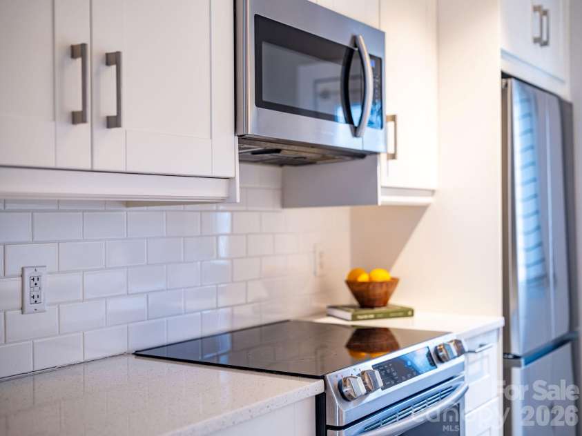 8 Lamar Avenue, Asheville, NC 28803.  MLS# CAR4365889, YatesRealty ID 10551. Sleek appliances, stone countertops