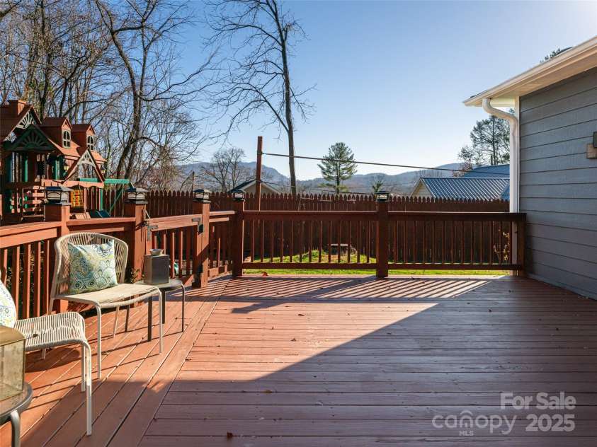 70 Wyatt Street, Asheville, NC 28803.  MLS# CAR4322963, YatesRealty ID 10553. Large wooden deck with fenced-in backyard surrounded by mountains.  Great privacy for entertaining