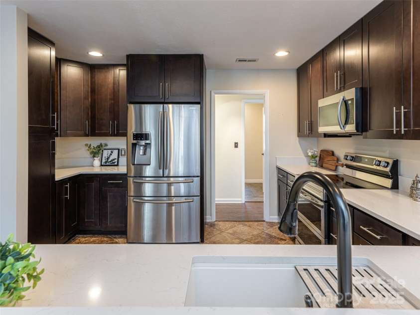 70 Wyatt Street, Asheville, NC 28803.  MLS# CAR4322963, YatesRealty ID 10553. Open kitchen with entry/exit on both sides leading to DR and hallway