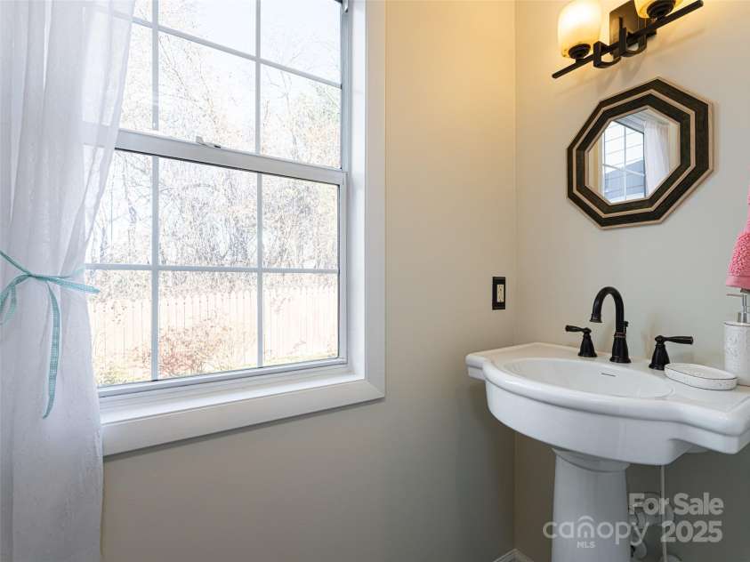 70 Wyatt Street, Asheville, NC 28803.  MLS# CAR4322963, YatesRealty ID 10553. Powder room/ half-bath on main level. Large window overlooking spacious back yard