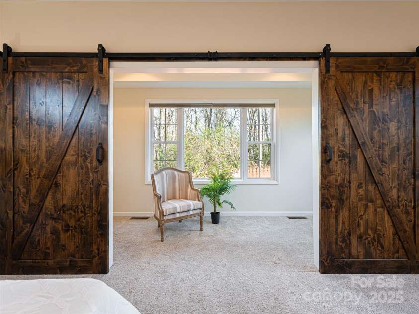 70 Wyatt Street, Asheville, NC 28803.  MLS# CAR4322963, YatesRealty ID 10553. Primary Bedroom #2 Office Area/ Exercise Room / Storage with Sliding Doors and large window overlooking nature