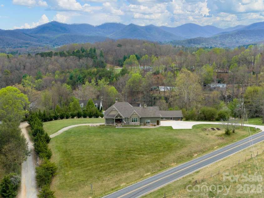 193 Youngs Cove Road, Candler, NC 28715.  MLS# CAR4363797, YatesRealty ID 10564. Large front and back yard spanning 2.36 acres