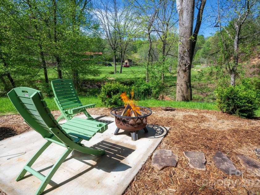 85 Laurel Cove Road, Candler, NC 28715.  MLS# CAR4251695, YatesRealty ID 10564. Detached Patio Next to the Creek is Perfect Spot for a Fire Pit