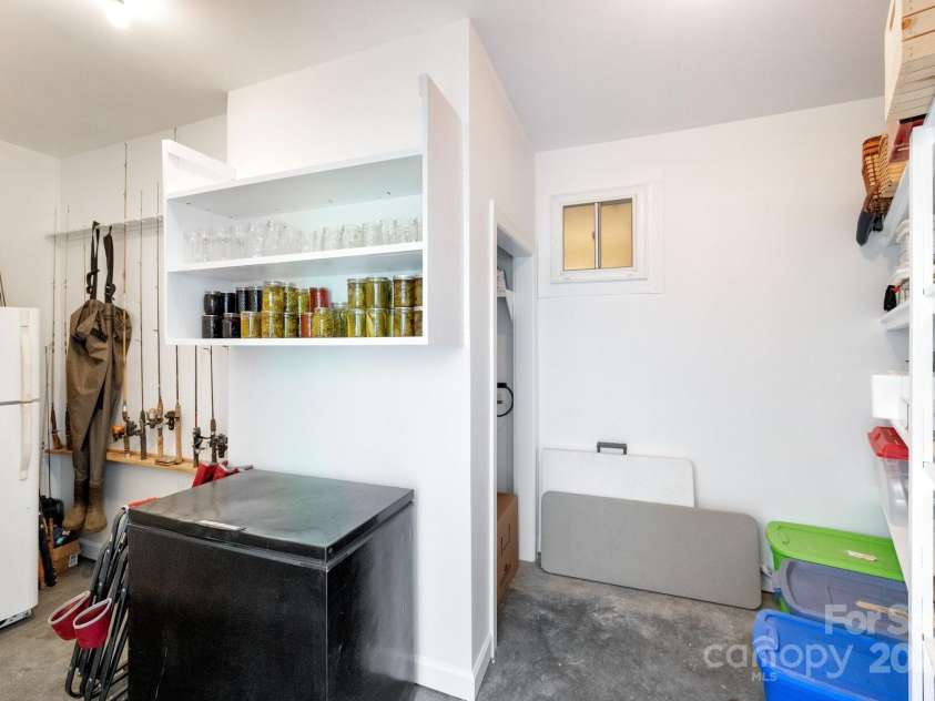 85 Laurel Cove Road, Candler, NC 28715.  MLS# CAR4251695, YatesRealty ID 10564. Extra Rooms in the Large Garage