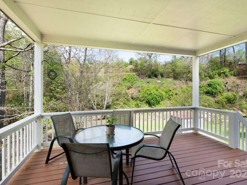 85 Laurel Cove Road, Candler, NC 28715.  MLS# CAR4251695, YatesRealty ID 10564. Serene Covered Deck Overlooks the Creek