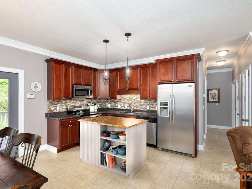 85 Laurel Cove Road, Candler, NC 28715.  MLS# CAR4251695, YatesRealty ID 10564. Upper Level Kitchen has Custom Island