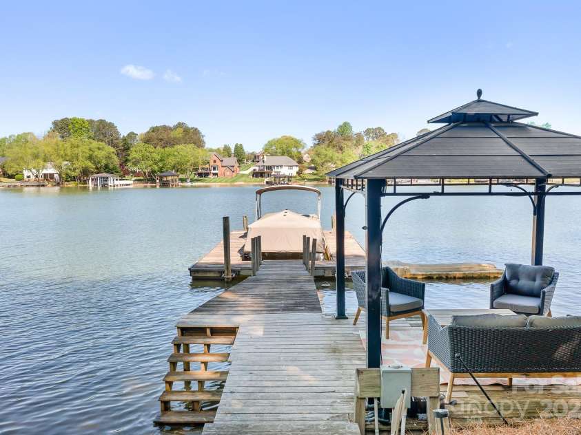 234 Winding Shore Road, Troutman, NC 28166.  MLS# CAR4245762, YatesRealty ID 10588. A floating dock, pier and fixed, covered sitting area to enjoy the shores of Lake Norman. There is a water pump that can be turned on to pull water from the lake. Very useful for cleaning the boat.