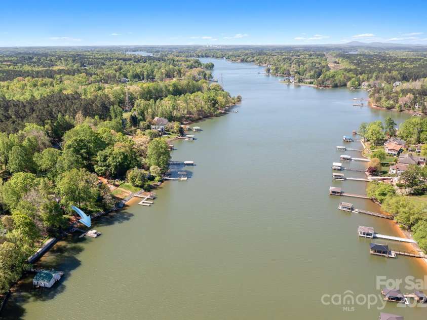234 Winding Shore Road, Troutman, NC 28166.  MLS# CAR4245762, YatesRealty ID 10588. Looking west out of the cove toward main channel. The property is on the left at the blue arrow.