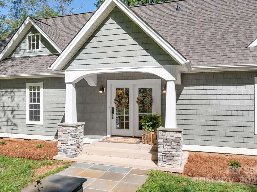 234 Winding Shore Road, Troutman, NC 28166.  MLS# CAR4245762, YatesRealty ID 10588. The covered front porch with a french door style entry.