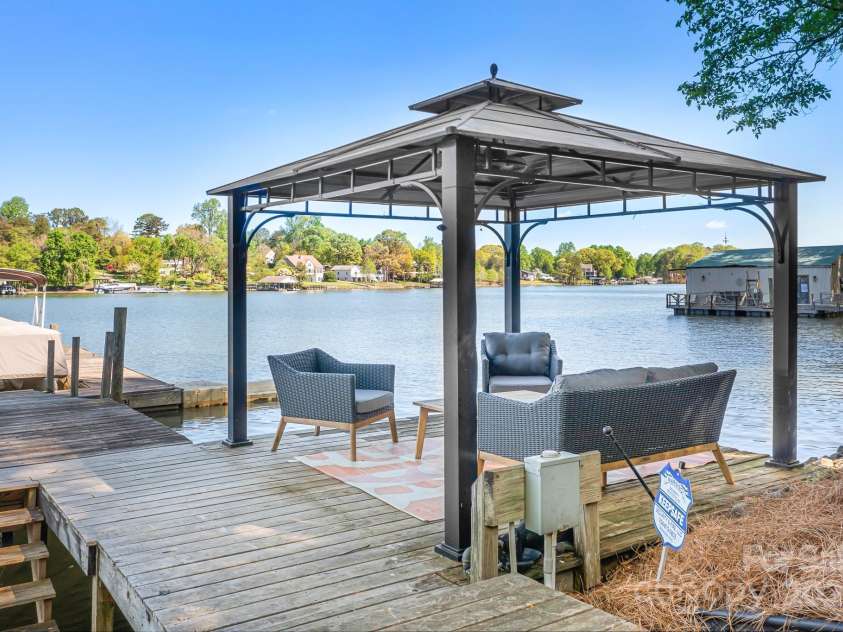 234 Winding Shore Road, Troutman, NC 28166.  MLS# CAR4245762, YatesRealty ID 10588. The covered sitting area provides relief from the hot sun at the waters breezy edge.