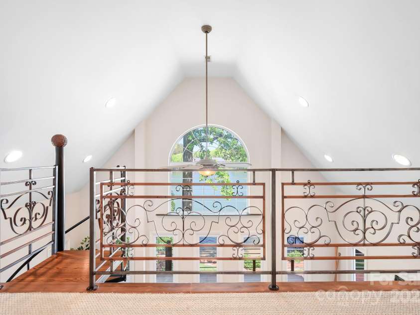 234 Winding Shore Road, Troutman, NC 28166.  MLS# CAR4245762, YatesRealty ID 10588. The upstairs landing looks down onto the sunroom and out to the lake.