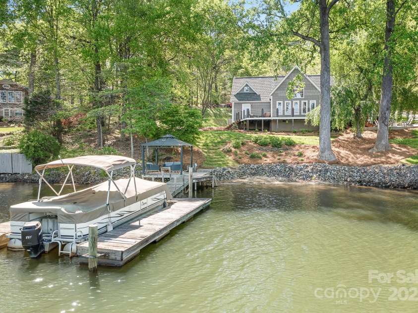 234 Winding Shore Road, Troutman, NC 28166.  MLS# CAR4245762, YatesRealty ID 10588. There is a natural sandy beach to enjoy with access from steps at the dock. The boat us for sale separately. Please call for details.